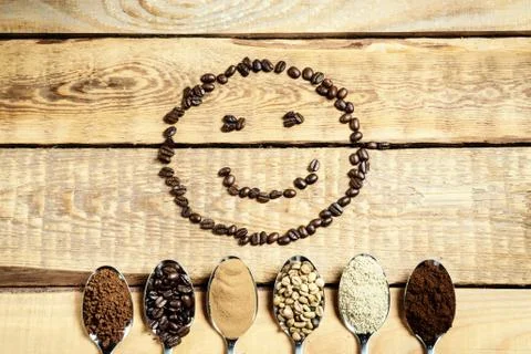 Spoons with different types of coffee and a smiling face Stock Photos
