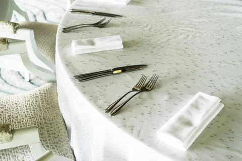 Spoons forks knives on the table serving ,served table in restaurant Stock Photos