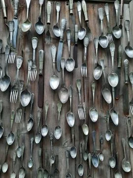 Spoons hanging on wall Foto stock