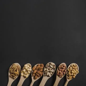 Spoons with various nuts Stock Photos