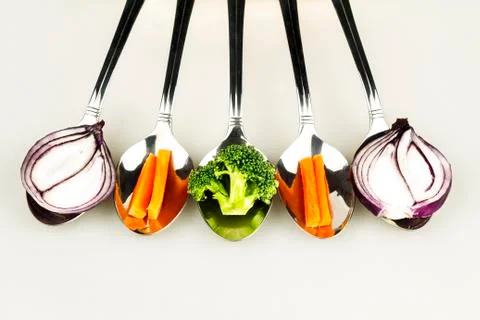Spoons with vegetables Photos