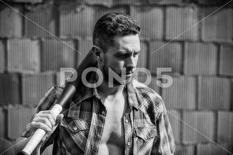 Sport activity. Hooligan man hits the bat. Bandit gang and conflict. aggression Stock Photos