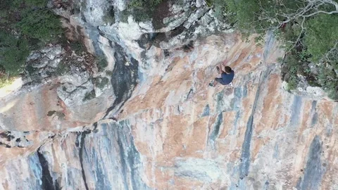 Sport climber rappelling down a mountain wall Video stock 167728069