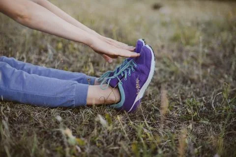 Sport concept,blue sneakers for running  with walkgirlslying on grass. Girl s Stock Photos