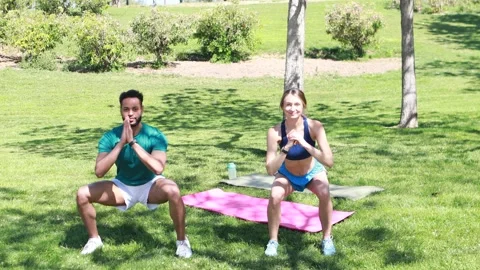 Sport couple doing side squads, working out together on roof top, outdoor class Video stock 250838635