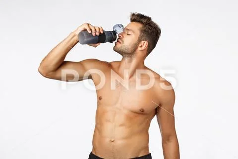 Sport, fitness and wellbeing concept. Handsome sexy young male athlete standing Stock Photos