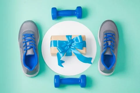 Sport flat lay composition dumbbells shoes gift Stock Photos