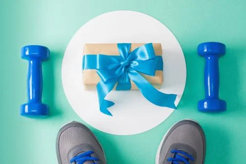 Sport flat lay composition dumbbells shoes gift Stock Photos