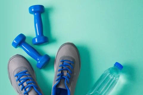 Sport flat lay composition dumbbells shoes bottle of water Stock Photos