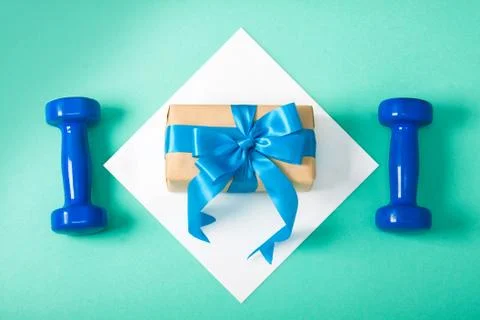 Sport flat lay composition dumbbells shoes gift Stock Photos