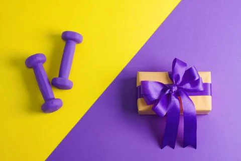 Sport flat lay composition with dumbbells and gift box Stock Photos