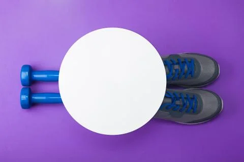 Sport flat lay composition dumbbells shoes white paper circle Stock Photos