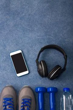 Sport flat lay composition dumbbells shoes water headphones Stock Photos