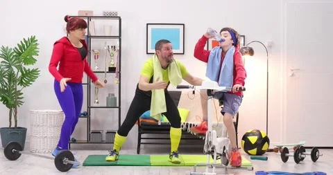 Sport is fun, A cute boy is training a bike at home, Family cheering him Stock Footage 152851009
