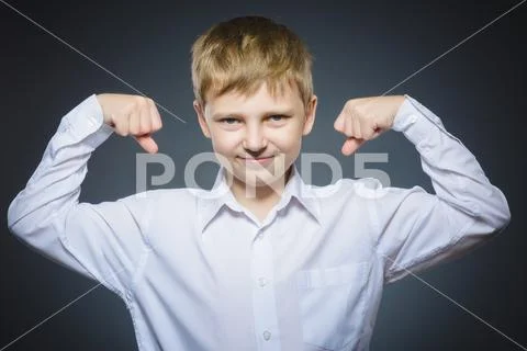 Sport Handsome Boy. Strong serious kid showing his hand biceps muscles Stock Photos