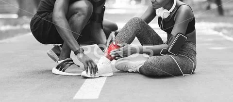 Sport Injuries. Black Girl Massaging Sprained Ankle, Suffering From Trauma Stock Photos