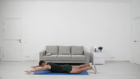 Sport man athlete do superman training. home sport training of athlete man do Stock Footage 223851153