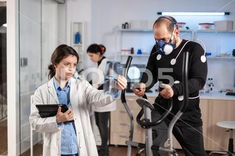 Photograph: Sport medical doctor looking at athlete x-ray #153213842