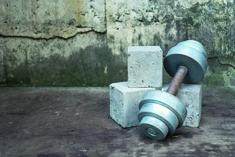 Sport mock up concrete cube empty podium with heavy metal dumbbell on grunge Stock Photos