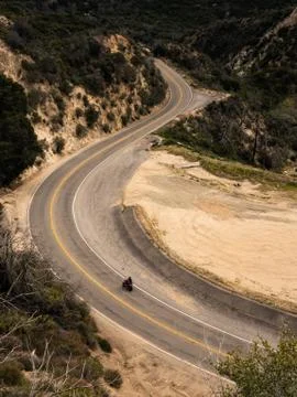 A Sport Motorcycle Speeds Through Some Twisty Turns Stock Photos