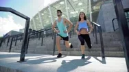 Sport, People, Exercising And Lifestyle Concept - Couple Doing Squats On City Stock Footage