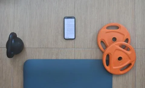 Sport set up material with a mobile at the flor for online training at home 스톡 사진