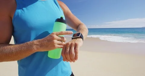Sport smartwatch - athlete runner using a activity tracker drinking water Stock Footage 101751684