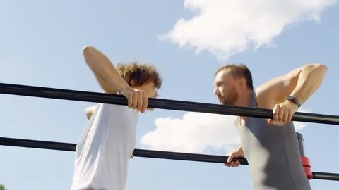 Sportive Couple Doing Dips on Parallel Bars Outdoor Video stock 97638202