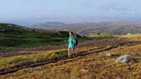 Sportive girl with dreadlocks walking using nordic poles Video stock 228952173