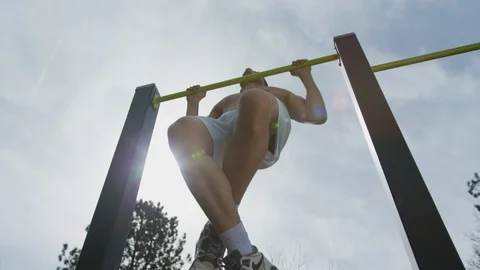 Sportive man doing pull-ups Stock Footage 100028430