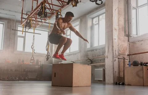 Sportive man performing functional training in gym Stock Photos
