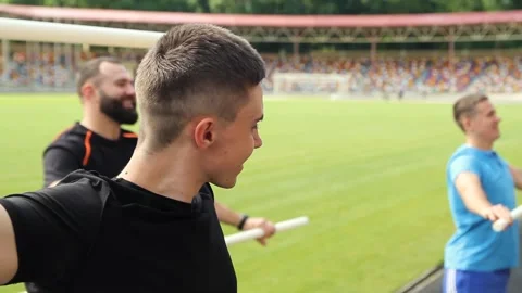 Sportive man, using pilates exercise body stick or bar while having workout at Stock Footage 130797553