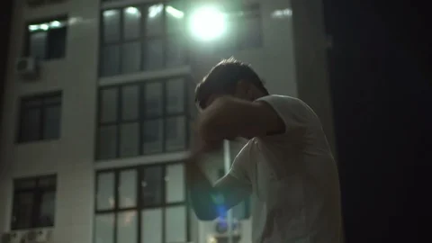 Sportive man warming up before start workout in evening downtown, runner guy Stock Footage 124428442