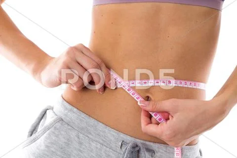 Sportive woman measuring her waist Stock Photos