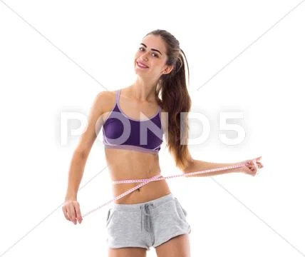 Sportive woman measuring her waist Stock Photos