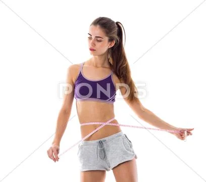 Sportive woman measuring her waist Stock Photos