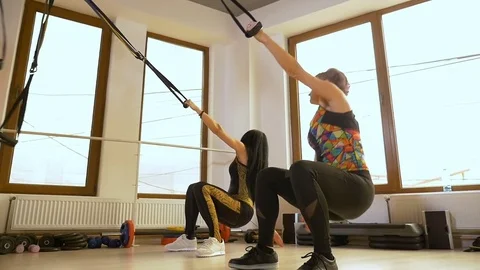 Sportive women doing push up exercise at the gym using fitness equipment Stock Footage 75398071