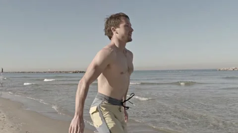 Sportman on the beach Stock Footage 58256020