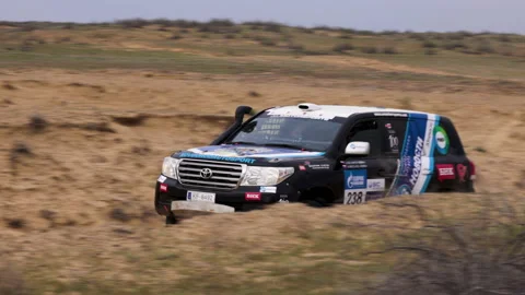 Sports car gets over the difficult part of the route during the Rally raid THE Video stock 153836645