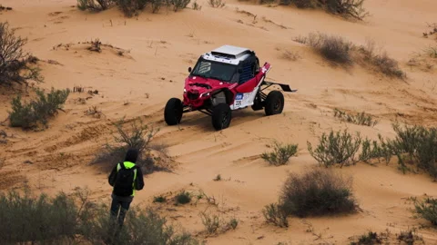 Sports car gets over the difficult part of the route during the Rally raid THE Video stock 153909856