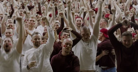 Sports crowd fans wearing red and white clothes celebrating during a sport event Stock Footage