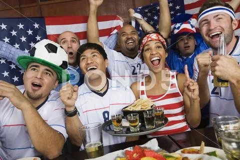 Sports Fans Drinking And Eating In Sports Bar