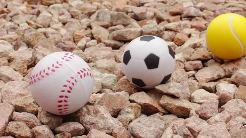 Sports game balls on stones Stock Footage