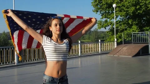 Sports girl on roller with the US flag. Independence Day. Stock Footage