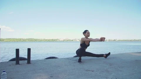 Sports girl training gymnastics near the pool in 4K Stock Footage