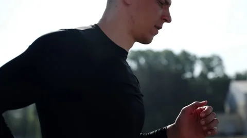 Sports jogging in an open space. A guy with a short haircut runs around the Stock Footage 243296736