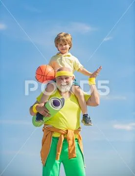 Sports for kids. Grandfather and child is doing sport outdoors. Happy fit senior Stock Photos