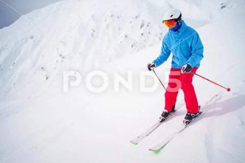 Sports Man Skiing On Snowy Slope.