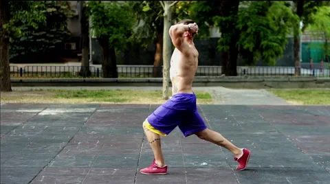 Sports Trainer doing exercizes on hamstrings by making squats,sport lifestyle 库存影片 51374598