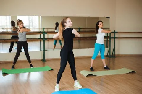 Sports woman doing aerobics. The concept of diet and healthy food and lifestile. Stock Photos
